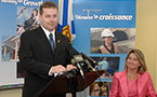 Education Minister Judy Streatch listens as Premier Rodney MacDonald announces investments in school construction.