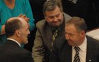 Finance Minister Graham Steele (left) shakes hands with Deputy Premier Frank Corbett (centre) beside a smiling Premier Darrell Dexter.